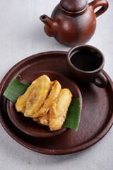 Wall Mural - Pisang goreng or banana fritters is popular street food in South East Asia, especially in Malaysia and Indonesia. Made from fried banana covered with sweet batter