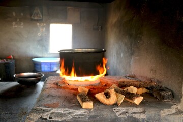 Traditional way of making food on open fire in old Indian kitchen in a village Chula.