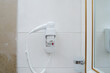 © AJ_stock_photos - hair dryer on the wall in the hotel bathroom