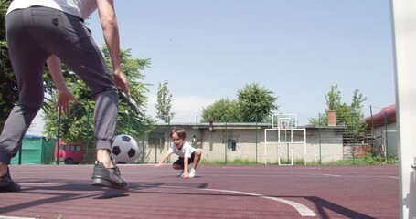 Sticker - Little boy and his father playing soccer outdoors