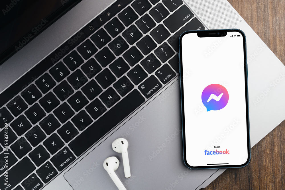 Facebook Messenger app on the smartphone screen on wooden background ...