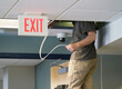 © nd700 - technician installing security camera in the office