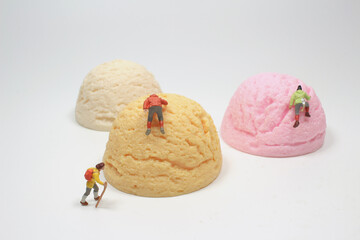 the fun of Mini people climbing the giant ice cream