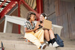 © PintoArt - multiethnic female friends, working with computer outdoors, telecommuting