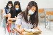 © EduLife Photos - Asian college students back to school with facemask and keep social distance while study in the classroom to prevent COVID-19 pandemic