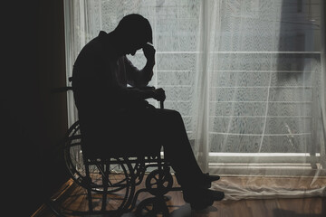 Wall Mural - Sad  guy in a wheelchair which he feeling  depressed  Cry, drama, lonely and unhappy concept.