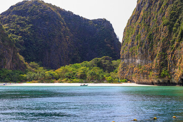 Wall Mural - Koh Phi Phi / Phi Phi Islands / Thailand - march 06 2020 Touring around this amazing Island that has one of the most beautiful beaches in Thailand with those iconic longtail boats everywhere.