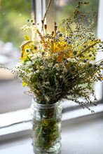 Floral Summer Or Autumn Background. A Bouquet Of Wild Flowers In A Vase On The Windowsill. Sunny Day, Blurred Background. Shallow Depth Of Field, Soft Focus.