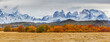 Panoramic image of an autumn landscape in the mountains: the Paine mountain range with the jagged peaks of Los Cuernos in southern Chile