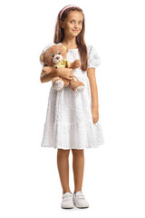 Wall Mural - Full length portrait of a girl in a white dress holding a teddy bear