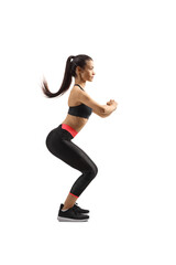 Wall Mural - Full length profile shot of a young female in sport clothes exercising