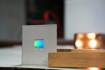 A diffraction grating sheet for studying the interference of visible light from a lamp. Physics science experiment. optical operation laboratory.