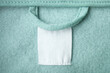 © Random435 - Cotton laundry care clothing label on fabric texture with place for text on fabric texture. Clothes with empty label or tag