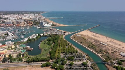 Wall Mural - Aerial video of the tourist Portuguese town of Vilamoura, with views of the beaches and docks for luxury yachts, hotels and restaurants. Portugal, Algarve.