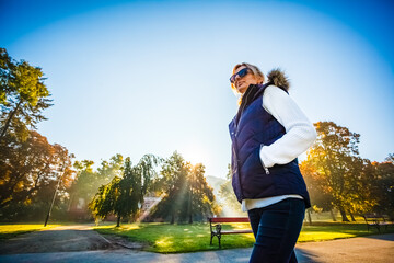 Wall Mural - middle-aged woman walking in city park