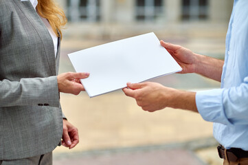 Wall Mural - Supervisor returning a folder with documents to a construction engineer