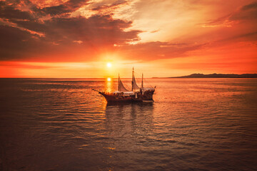 Pirate boat with a beautiful sunset as the background, the boat name is Marigalante and Iconic ship at Puerto Vallarta