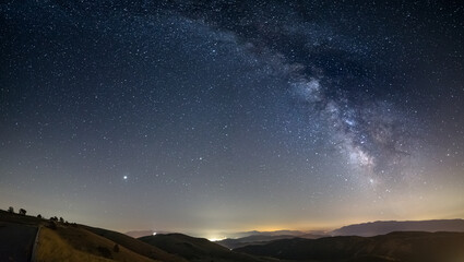 Wall Mural - panoramic night sky over santo stefano di sessanio, abruzzo and rocca calascio, italy. the milky way