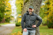 © MNStudio - Portrait of an attractive middle age man in beautiful autumn park.