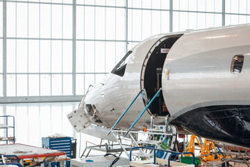 Maintenance of airplane in the large white hangar