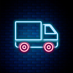 Sticker - Glowing neon line Delivery cargo truck vehicle icon isolated on brick wall background. Colorful outline concept. Vector