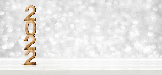 Leinwandbilder - 2022 happy new year wood number (3d rendering) on wood table with sparkling silver bokeh wall,leave space for display of product for promotion on christmas and new year holiday