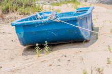 Old Blue Flat Bottom Boat On Beach During Low Tide.