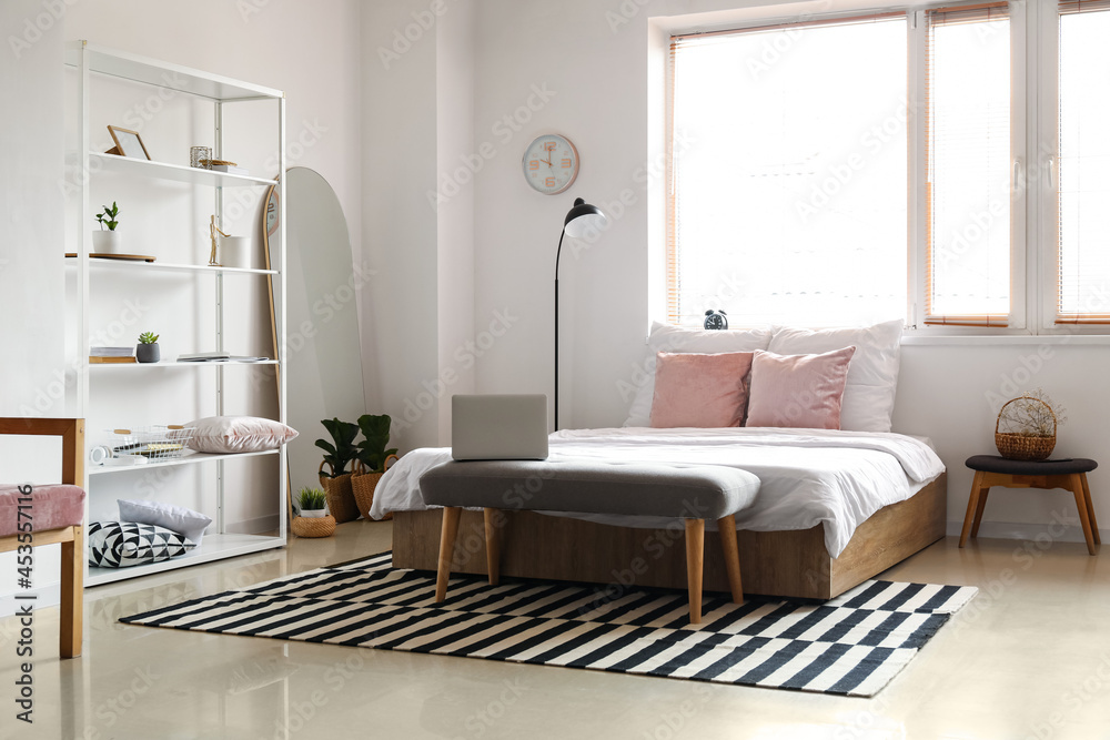 Stylish interior of modern bedroom with mirror