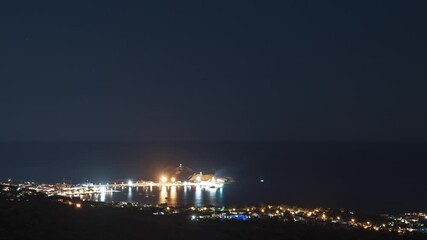 Wall Mural - Night time time-lapse of La Pietra and passing boats at Ile Rousse in the Balagne region of Corsica