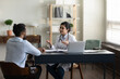 © fizkes - Confident skilled young indian female general practitioner doctor in medical uniform giving professional healthcare consultation to african american patient at checkup meeting in clinic office.