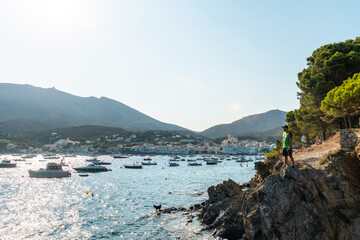 Wall Mural - A young man on summer vacation in Cadaques by the sea, Costa Brava of Catalonia, Gerona, Mediterraneo. Spain