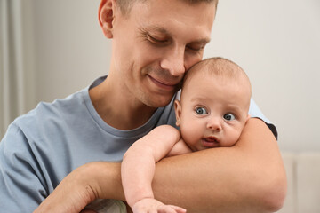 Sticker - Happy father holding his cute baby at home, closeup