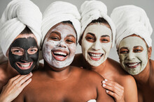 Multigenerational Women Having Fun Wearing Face Beauty Mask For Skin Care Therapy - Main Focus On African Girl Face