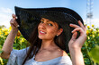 © ako-photography - closeup portrait of woman in elegant hat enjoying summer sun, pattern of shadows falling on her face