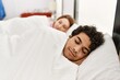 © Krakenimages.com - Young couple smiling happy sleeping on the bed at bedroom.
