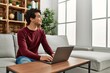 © Krakenimages.com - Young hispanic man using laptop sitting on the sofa at home.