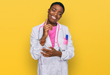 Sticker - Young african american woman wearing doctor uniform and stethoscope with a big smile on face, pointing with hand and finger to the side looking at the camera.