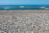Fototapeta Paryż - grey and white pebble beach on the mediterranean sea