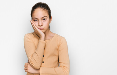 Beautiful brunette little girl wearing casual sweater thinking looking tired and bored with depression problems with crossed arms.