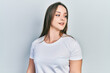 © Krakenimages.com - Young hispanic girl wearing casual white t shirt looking to side, relax profile pose with natural face and confident smile.