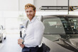 © ViDi Studio - Confident minded man customer buyer businessman client wears white shirt chooses auto wants to buy new automobile in car showroom vehicle salon dealership store motor show indoor. Car sales concept