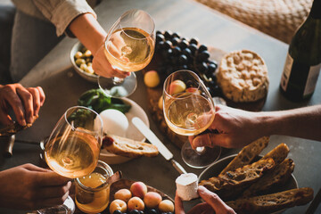 Group of unrecognizable people holding glasses of wine