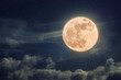 Amazing full moon on blue night sky with stars and clouds. Halloween wallpaper