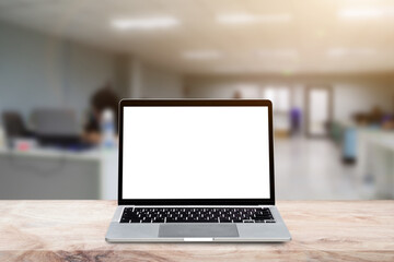 Wall Mural - Laptop computer with blank screen on wood table over blur background. Mock up, template for your design.