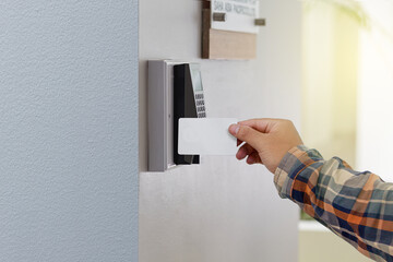 Wall Mural - Man or woman use key card for access electronic door  control machine. Holding key card to access the door security systems. Selective focus