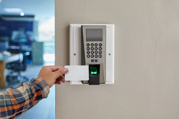 Wall Mural - Man or woman use key card for access electronic door  control machine. Holding key card to access the door security systems. Selective focus