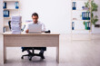© Elnur - Young male employee unhappy with excessive work