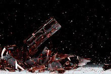3d Render Of A Broken Brown Beer A Bottle With Many Fragments Flying In Different Directions   On A Black Background.