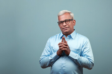 Wall Mural - Portrait of a happy mature man of Indian ethnicity 