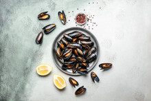Plate With Raw Mussels And Lemon On Color Background